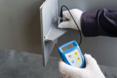 Checking thickness paint by Dry Film Thickness (DFT) for painting on steel structure.